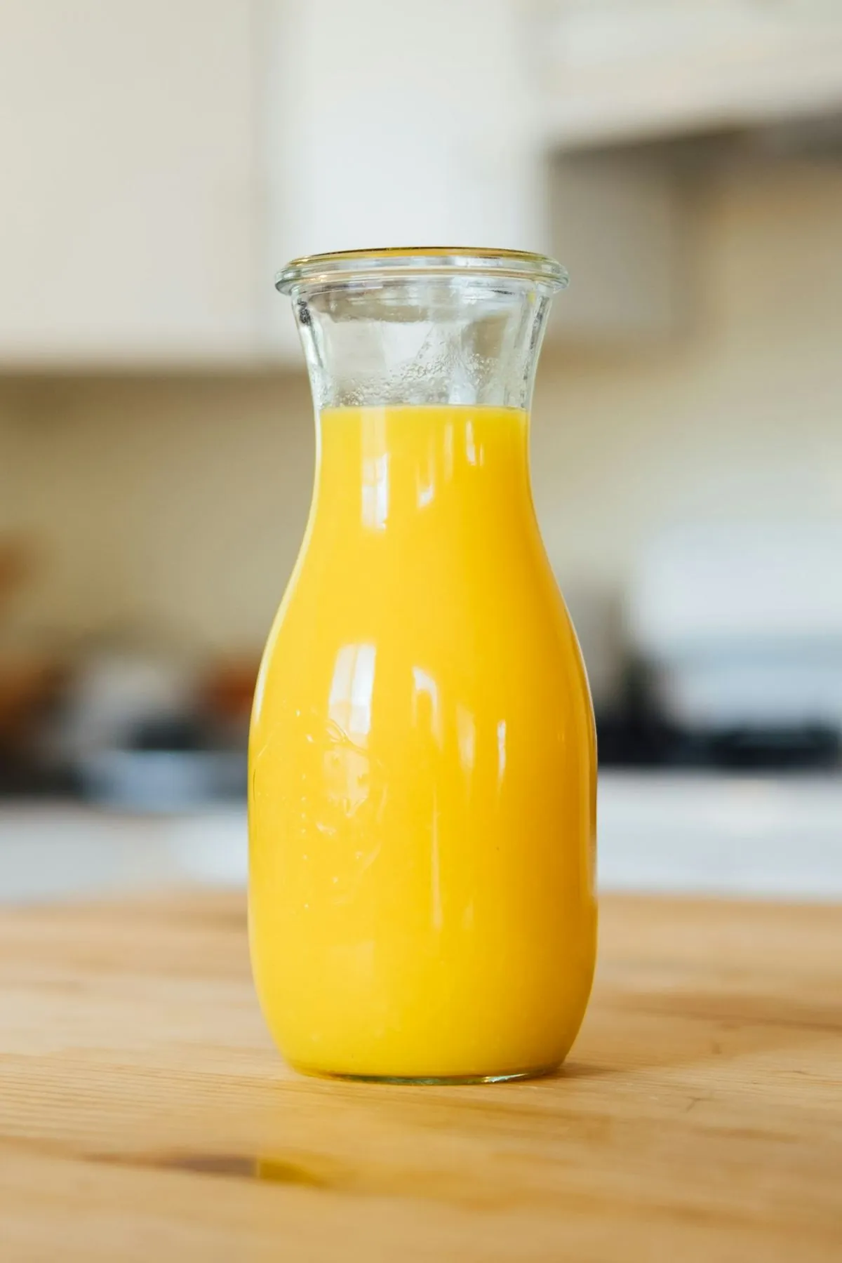 A glass bottle of fresh orange juice